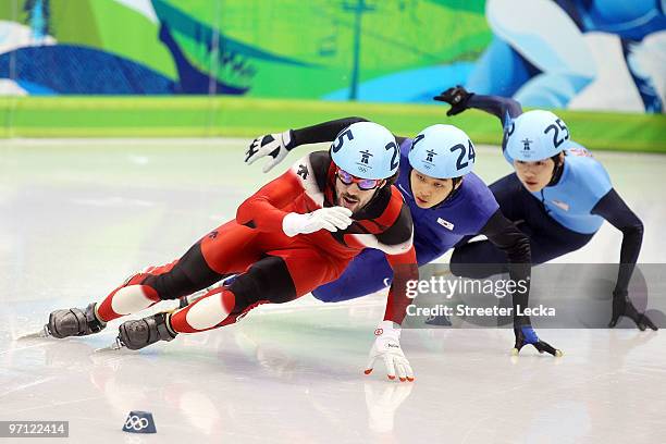 Charles Hamelin of Canada leads from Sung Si-Bak of South Korea and Simon Cho of the United States in the Men's 500m Short Track Speed Skating...