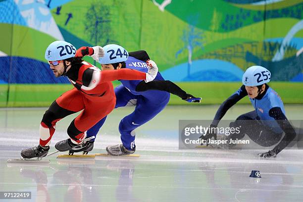 Charles Hamelin of Canada leads from Sung Si-Bak of South Korea and Simon Cho of the United States in the Men's 500m Short Track Speed Skating...