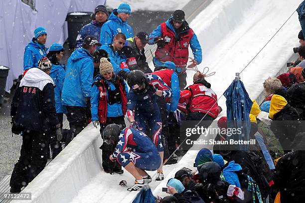 John Napier, Charles Berkeley, Steven Langton and Christopher Fogt of the United States crash in USA 2 during the four-man bobsleigh heat 2 on day 15...