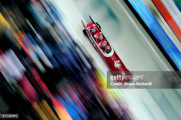Dawid Kupczyk, Michal Zblewski, Pawel Mroz and Marcin Piotr Niewiara of Poland compete in Poland 1 during the four-man bobsleigh heat 2 on day 15 of...