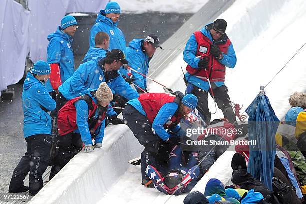 John Napier, Charles Berkeley, Steven Langton and Christopher Fogt of the United States crash in USA 2 during the four-man bobsleigh heat 2 on day 15...