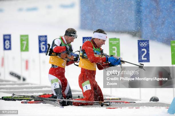 Emil Hegle Svendsen of Norway, Dominik Landertinger of Austria during the MenÕs Biathlon 4x7.5km Relay on Day 15 of the 2010 Vancouver Winter Olympic...