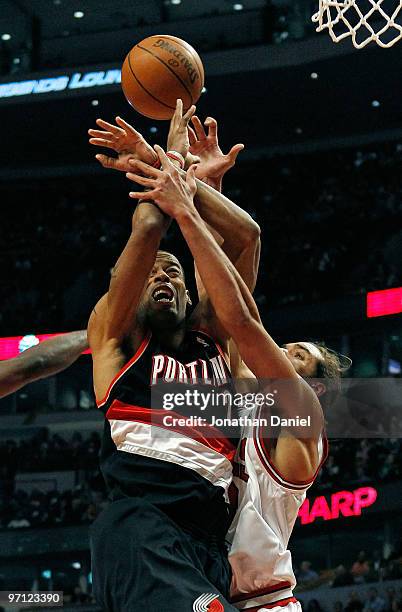Joakim Noah of the Chicago Bulls gets tangled up with Marcus Camby of the Portland Trail Blazers at the United Center on February 26, 2010 in...