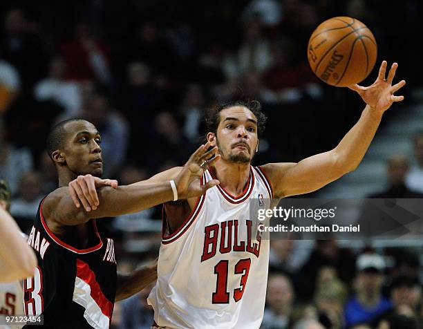 Joakim Noah of the Chicago Bulls grabs a pass under pressure from Dante Cunningham of the Portland Trail Blazers at the United Center on February 26,...