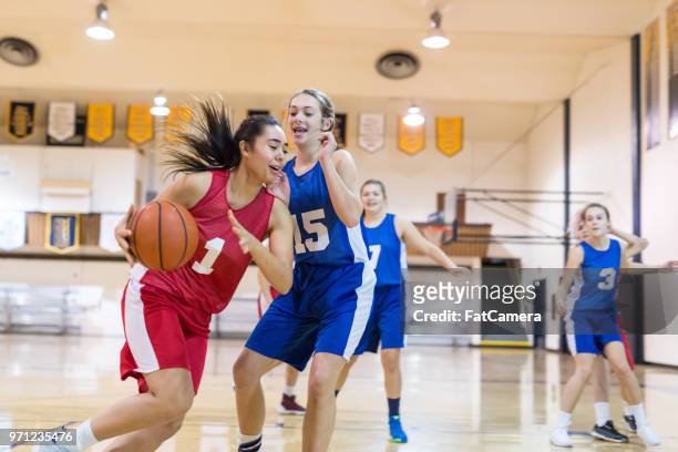 girls high school basketball game - blocking sports activity stock pictures, royalty-free photos & images
