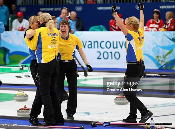 Anette Norberg, Eva Lund, Cathrine Lindahl and Anna Le Moine celebrate after victory over Canada in the women's gold medal curling game between...