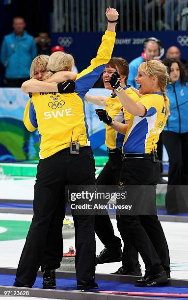 Anette Norberg, Eva Lund, Cathrine Lindahl and Anna Le Moine celebrate after victory over Canada in the women's gold medal curling game between...