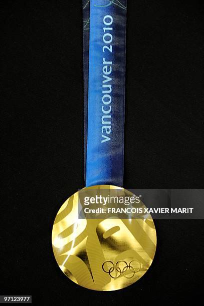 The official gold medal of the Vancouver 2010 Winter Olympics is displayed during a presentation at the Main press center in Vancouver on February...