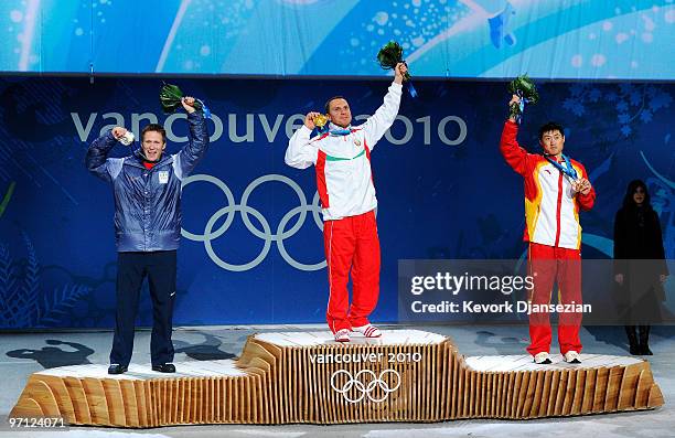 Jeret Peterson of the United States celebrates winning the silver medal, Alexei Grishin of Belarus gold and Liu Zhongqing of China bronze during the...