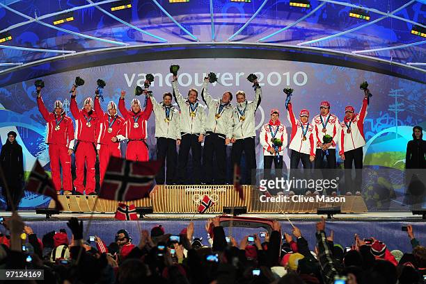 Team Austria celebrates winning the silver medal, team Norway gold and team Russia bronze during the medal ceremony for the men�s 4 x 7.5 biathlon...