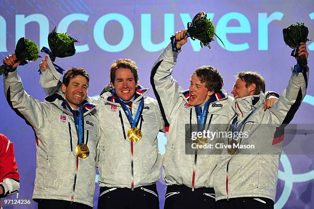 Ole Einar Bjoerndalen, Emil Hegle Svendsen, Tarjei Boe and Halvard Hanevold of Norway celebrate winning the gold medal during the medal ceremony for...