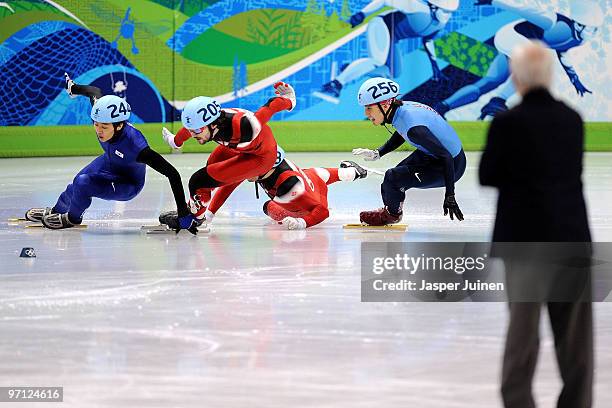 Charles Hamelin of Canada takes the lead as Francois-Louis Tremblay of Canada and Sung Si-Bak of South Korea crash watched by Apolo Anton Ohno of the...