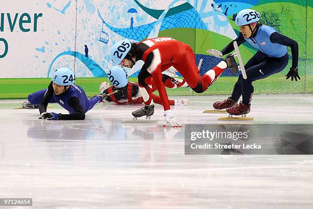 Charles Hamelin of Canada takes the lead as Francois-Louis Tremblay of Canada and Sung Si-Bak of South Korea crash watched by Apolo Anton Ohno of the...