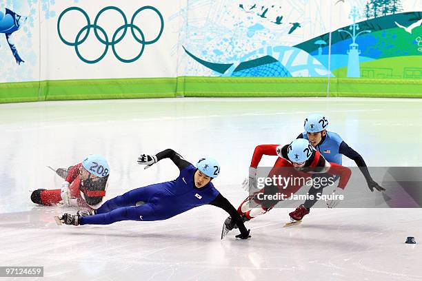 Charles Hamelin of Canada takes the lead as Francois-Louis Tremblay of Canada and Sung Si-Bak of South Korea crash in the Men's 500m Short Track...