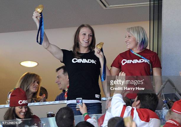 Heather Moyse and Kaillie Humphries shows their gold medals as they attend the ice hockey men's semifinal game between the Canada and Slovakia on day...