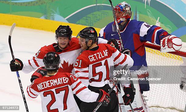 Ryan Getzlaf#51 of Canada celebrates with his team mates after he scored past Goalkeeper Jaroslav Halak of Slovakia during the ice hockey men's...