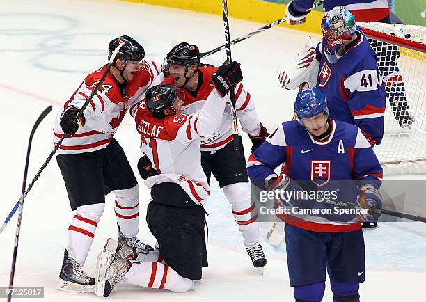 Ryan Getzlaf#51 of Canada celebrates with his team mates after he scored past Goalkeeper Jaroslav Halak of Slovakia during the ice hockey men's...