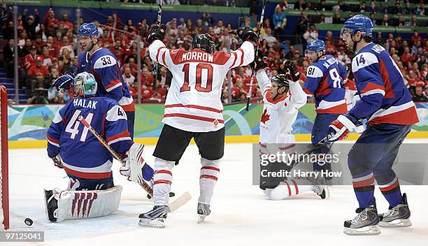 Ryan Getzlaf#51 of Canada celebrates with his team mates after he scored past Goalkeeper Jaroslav Halak of Slovakia during the ice hockey men's...