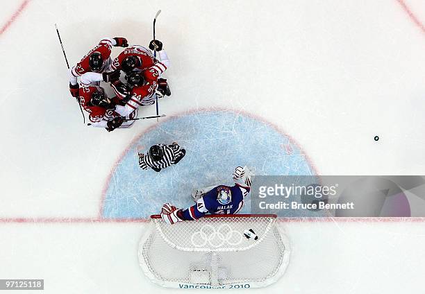 Ryan Getzlaf#51 of Canada celebrates with his team mates after he scored past Goalkeeper Jaroslav Halak of Slovakia during the ice hockey men's...