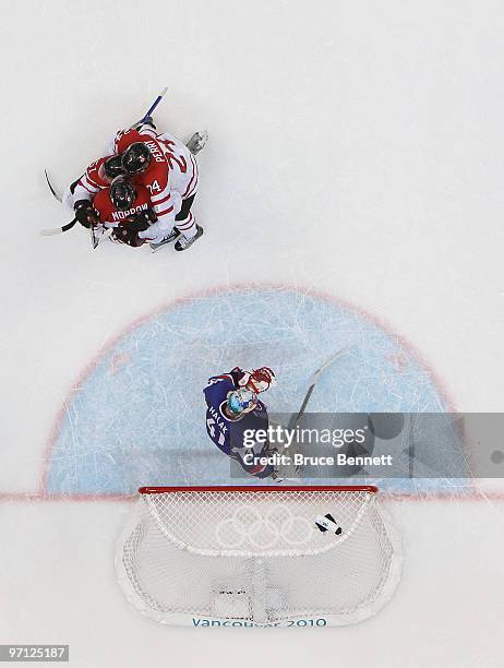 Ryan Getzlaf#51 of Canada celebrates with his team mates after he scored past Goalkeeper Jaroslav Halak of Slovakia during the ice hockey men's...