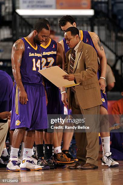 Assistant coach Rasheed Hazzard talks with Joe Crawford and Dar Tucker of the Los Angeles D-Fenders on the sidelines during a break in the NBA...