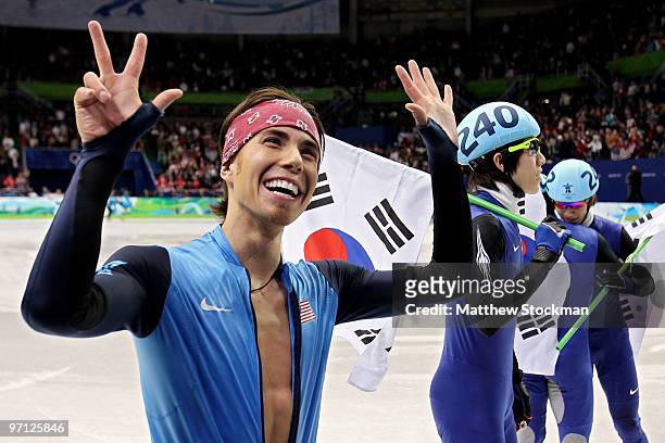 Bronze medalist Apolo Anton Ohno of the United States holds up eight fingers to signify his tally of Olympic medals after the Men's 5000m Relay Short...