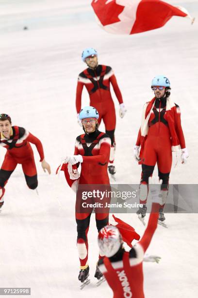 Olivier Jean of Canada leads the celebrations after Canada won the gold medal in the Men's 5000m Relay Short Track Speed Skating Final on day 15 of...