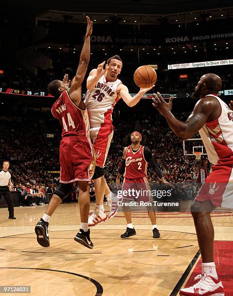 Hedo Turkoglu of the Toronto Raptors finds the open man in the paint, passing around Leon Powe of the Cleveland Cavaliers on February 26, 2010 at the...