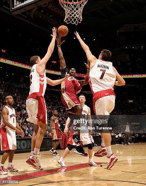 Antawn Jamison of the Cleveland Cavaliers drives the paint and splits defenders Rasho Nesterovic and Andrea Bargnani of the Toronto Raptors during a...