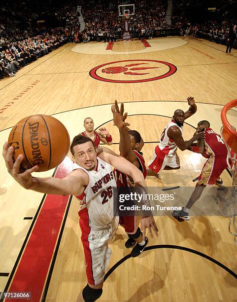 Hedo Turkoglu of the Toronto Raptors drives hard to the basket and tries the layup past Leon Powe of the Cleveland Cavaliers on February 26, 2010 at...