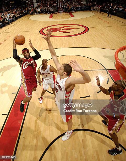 Mo Williams of the Cleveland Cavaliers looks to sink the floater over Rasho Nesterovic of the Toronto Raptors during a game on February 26, 2010 at...