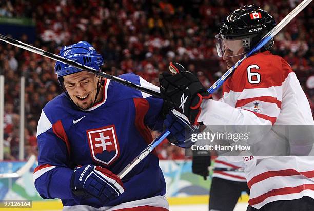 Shea Weber of Canada is hit by a stick during the ice hockey men's semifinal game between the Canada and Slovakia on day 15 of the Vancouver 2010...