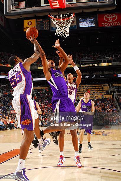 Dominic McGuire of the Sacramento Kings goes up for a layup against Earl Clark and Channing Frye of the Phoenix Suns during the game at U.S. Airways...