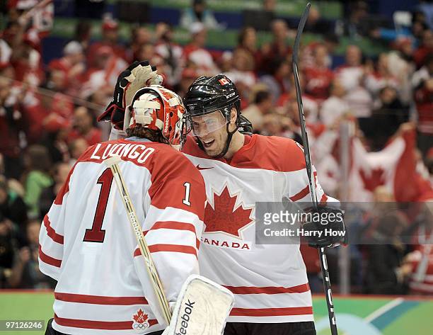 Goalkeeper Roberto Luongo of Canada celebrates with Ryan Getzlaf of Canada after Canada won the ice hockey men's semifinal game between the Canada...