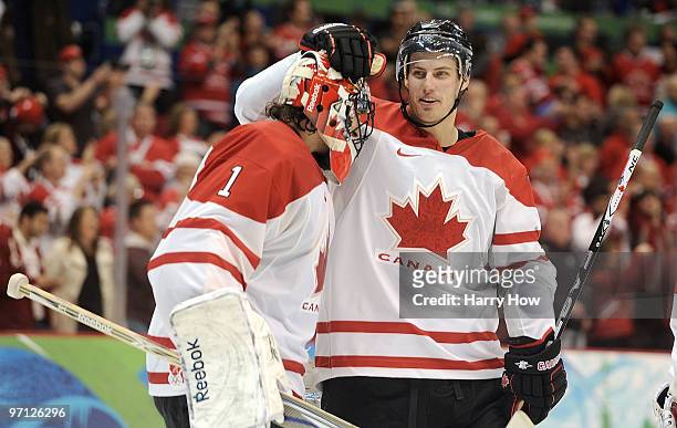 Goalkeeper Roberto Luongo of Canada celebrates with his team mate Ryan Getzlaf of Canada after Canada won the ice hockey men's semifinal game between...