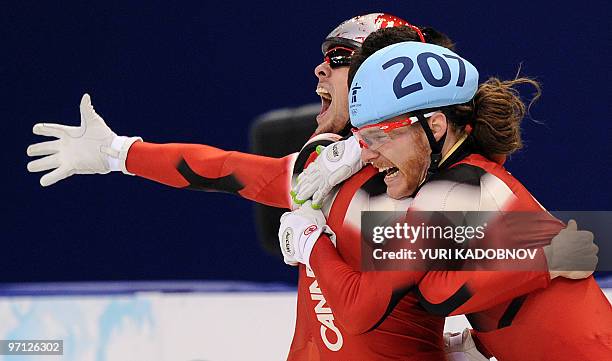 Canada's gold medallist Olivier Jean celebrates at the end of the Men's 5000 m relay short-track final at the Pacific Coliseum in Vancouver, during...