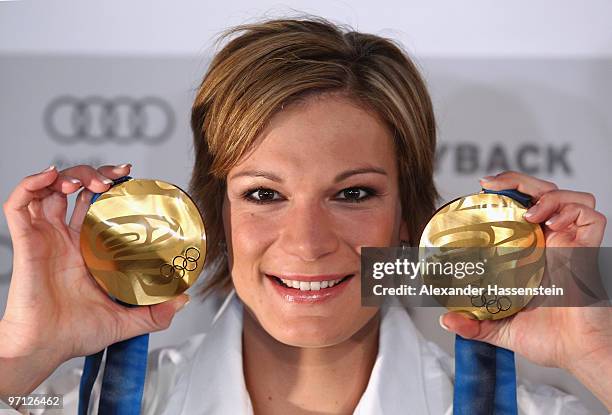 Alpine skier Maria Riesch of Germany poses with her gold medals for the ladies' super combined and ladies' slalom on day 15 of the Vancouver 2010...