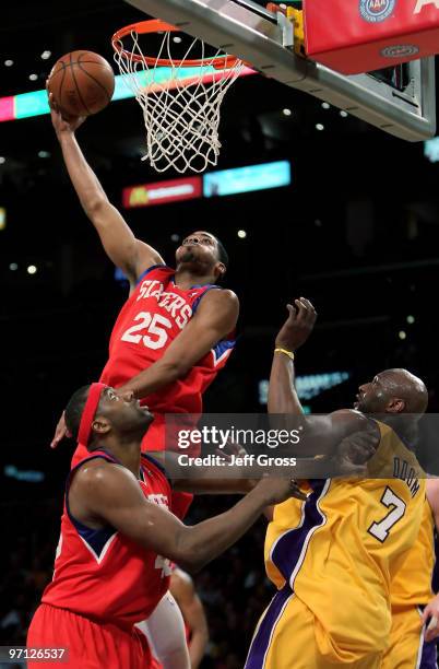 Rodney Carney of the Philadelphia 76ers shoots over teammate Elton Brand and Lamar Odom of the Los Angeles Lakers in the first half at Staples Center...