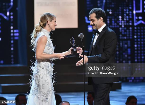 Kelli O'Hara presents Tony Shalhoub with the award for Best Performance by an Actor in a Leading Role in a Musical for The Band's Visit onstage...