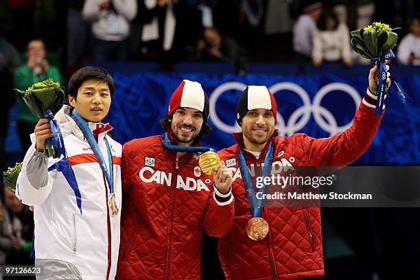 Gold medalist Charles Hamelin of Canada celebrates with silver medalist Sung Si-Bak and bronze medalist Francois-Louis Tremblay of Canada in the...