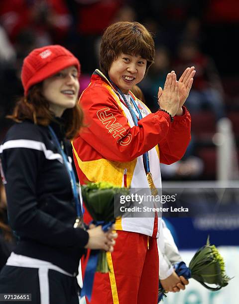 Gold medalist Wang Meng of China celebrates with silver medalist Katherine Reutter of the United States after the Ladies 1000m Short Track Speed...