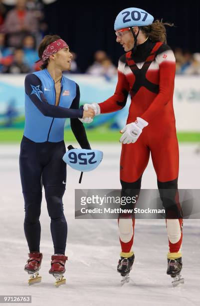 Apolo Anton Ohno of the United States shakes hands with Olivier Jean of Canada after Canada won the gold medal and the United States won bronze in...
