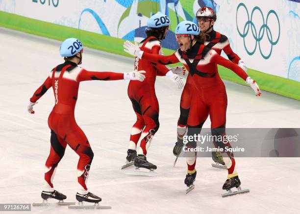 Olivier Jean of Canada leads the celebrations with Charles Hamelin, Francois Hamelin and Francois-Louis Tremblay after Canada won the gold medal in...