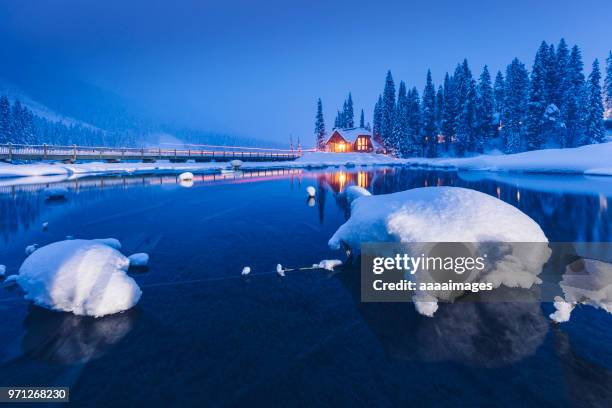 a small resort lodge at lakeshore in winter landscape - canadian rocky mountains snow stock-fotos und bilder
