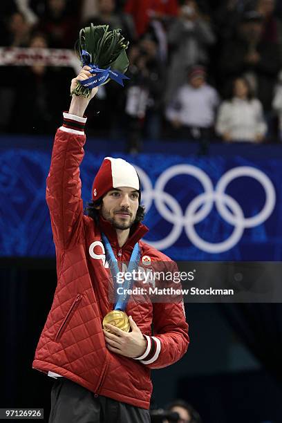 Charles Hamelin of Canada celebrates winning the gold medal in the Men's 500m Short Track Speed Skating Final during the flower ceremony on day 15 of...