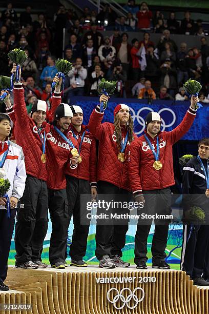 Charles Hamelin of Canada celebrates the gold medal with team mates Olivier Jean, Francois Hamelin, Francois-Louis Tremblay and Guillaume Bastille...