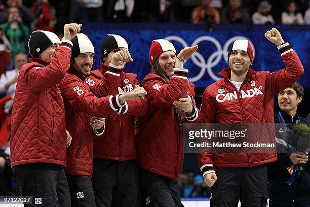 Charles Hamelin of Canada celebrates the gold medal with teammates Olivier Jean, Francois Hamelin, Francois-Louis Tremblay and Guillaume Bastille...
