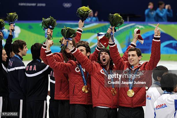 Charles Hamelin of Canada celebrates the gold medal with team mates Olivier Jean, Francois Hamelin, Francois-Louis Tremblay and Guillaume Bastille...