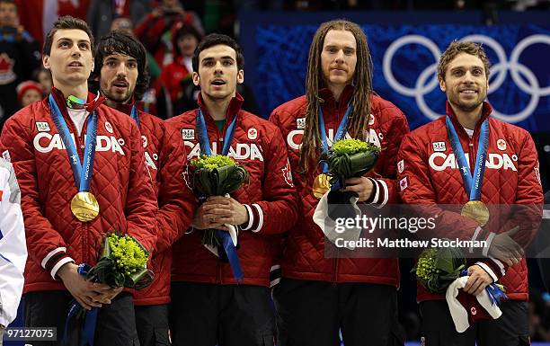 Charles Hamelin of Canada celebrates the gold medal with teammates Olivier Jean, Francois Hamelin, Francois-Louis Tremblay and Guillaume Bastille...