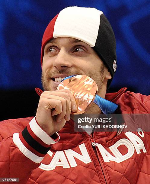 Bronze medallist Canada's Francois-Louis Tremblay poses on the podium during the medal ceremony at the end of the Men's 500 m short-track final at...